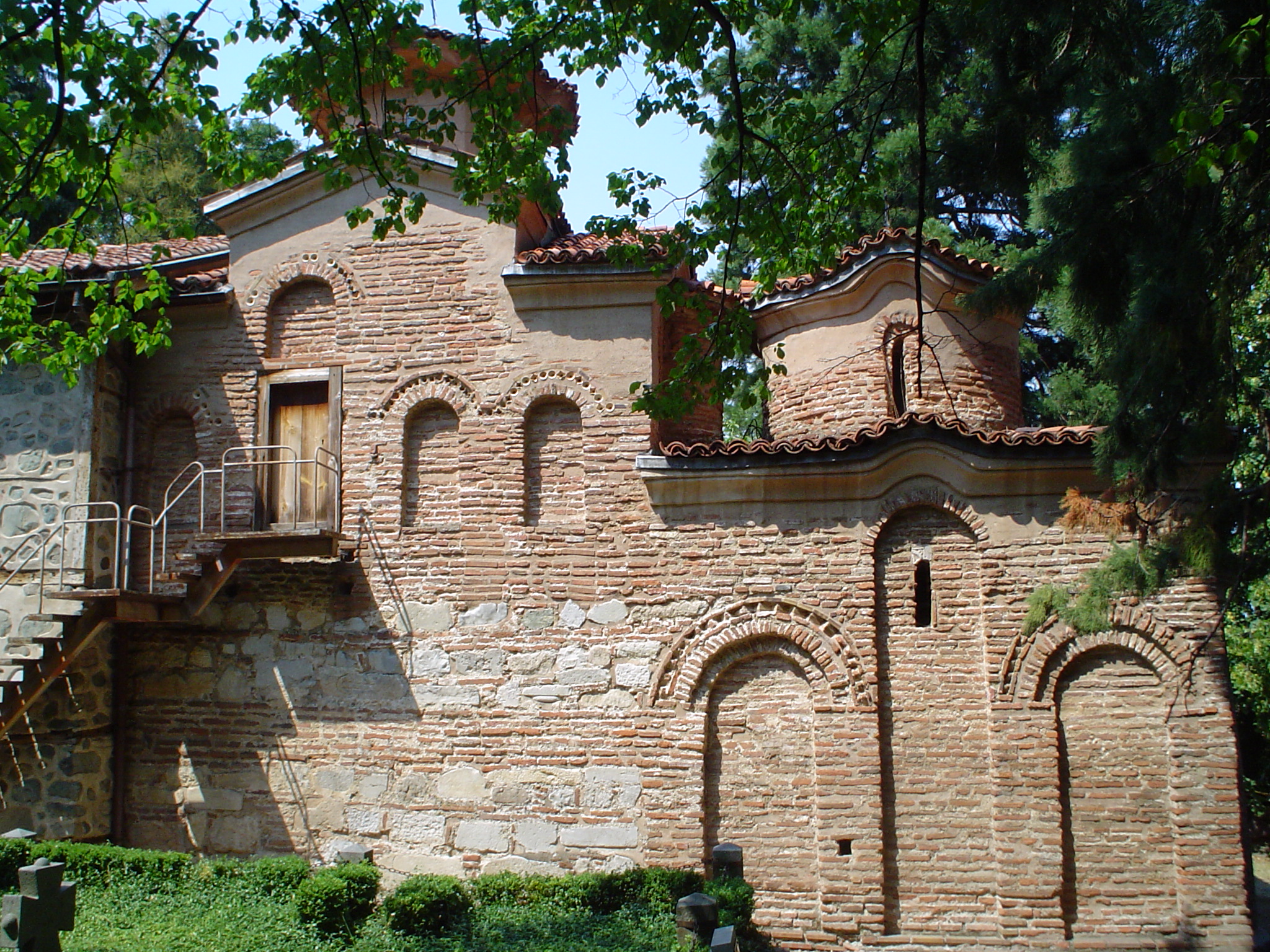 UNESCO Boyana Church stone facade nestled among century-old pine trees