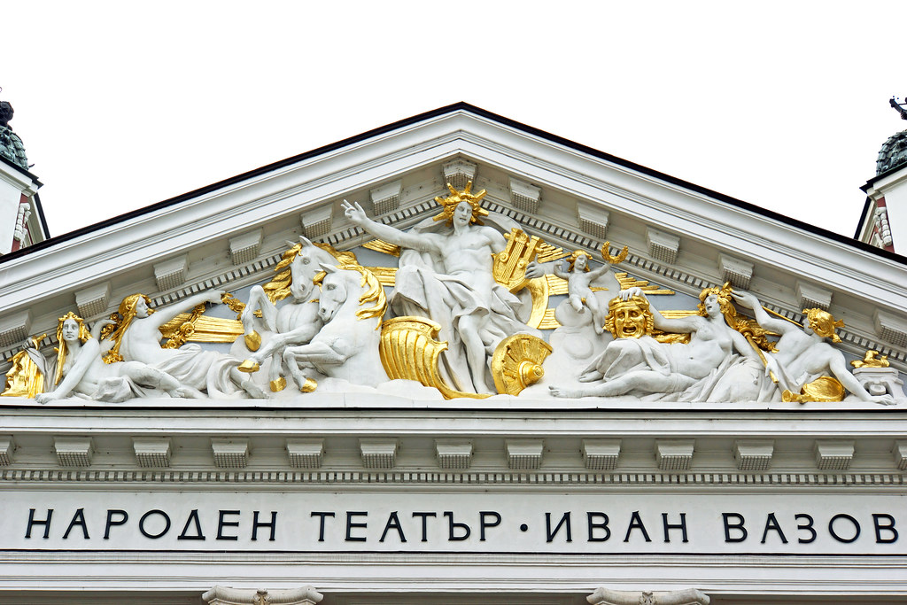 Ivan Vazov National Theatre illuminated at twilight in Sofia's City Garden